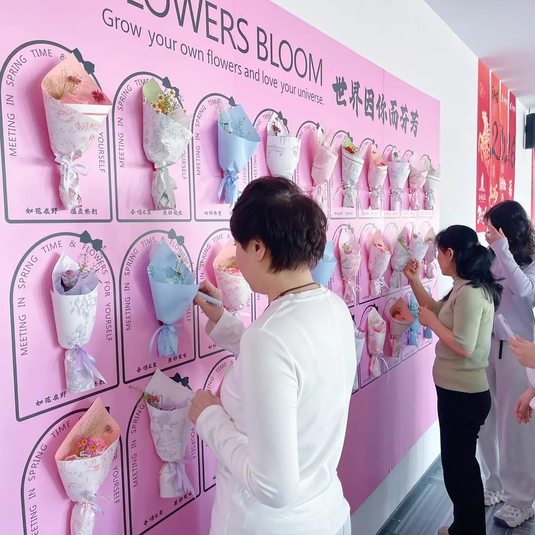 Writing cards at the flower wall after class